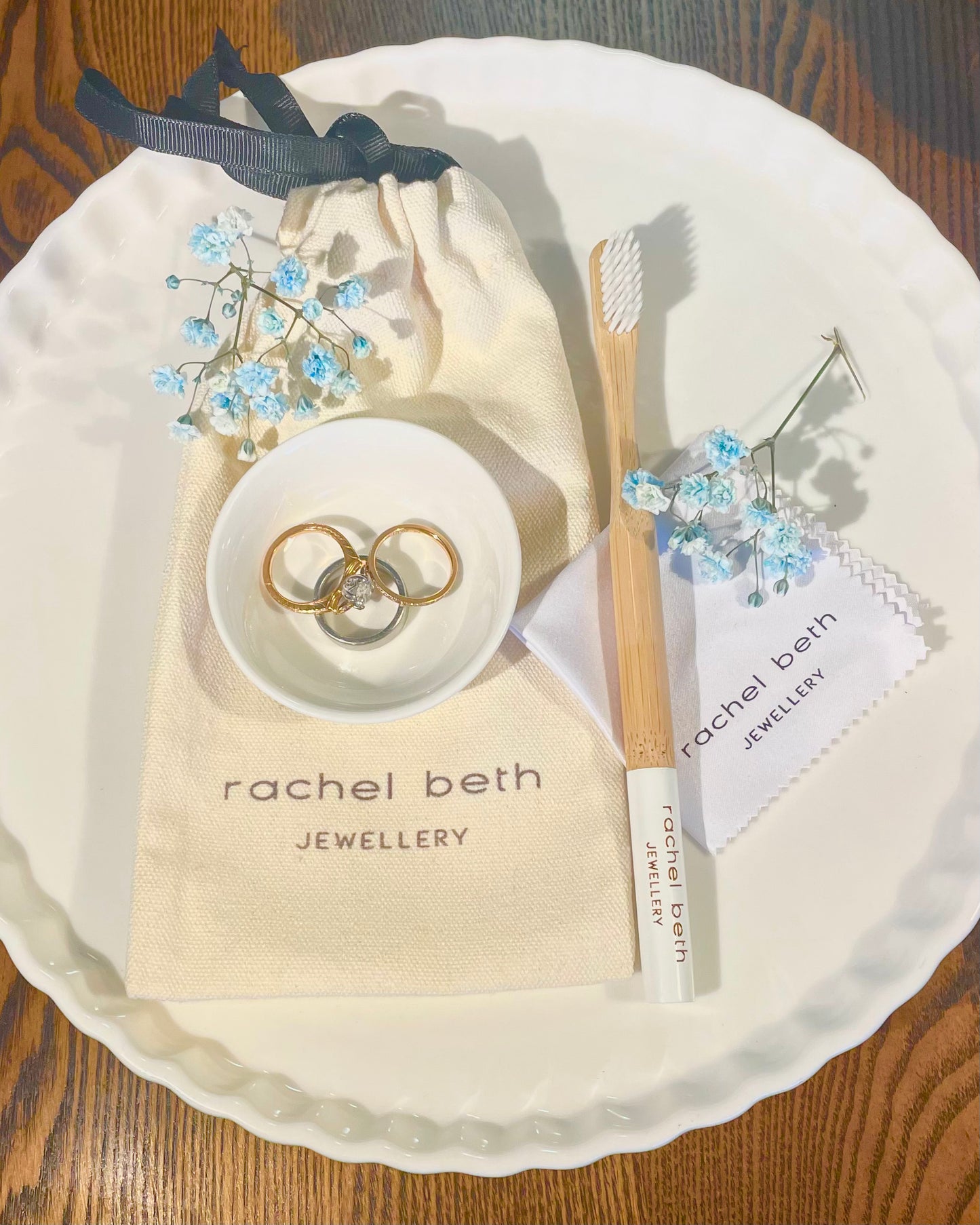 At Home Rachel Beth Jewellery Cleaning Kit This includes: - Ceramic tricket tray/cleaning bowl - Bamboo 100% biodegradable cleaning brush - Cleaning cloth - Eco friendly canvas linen bag