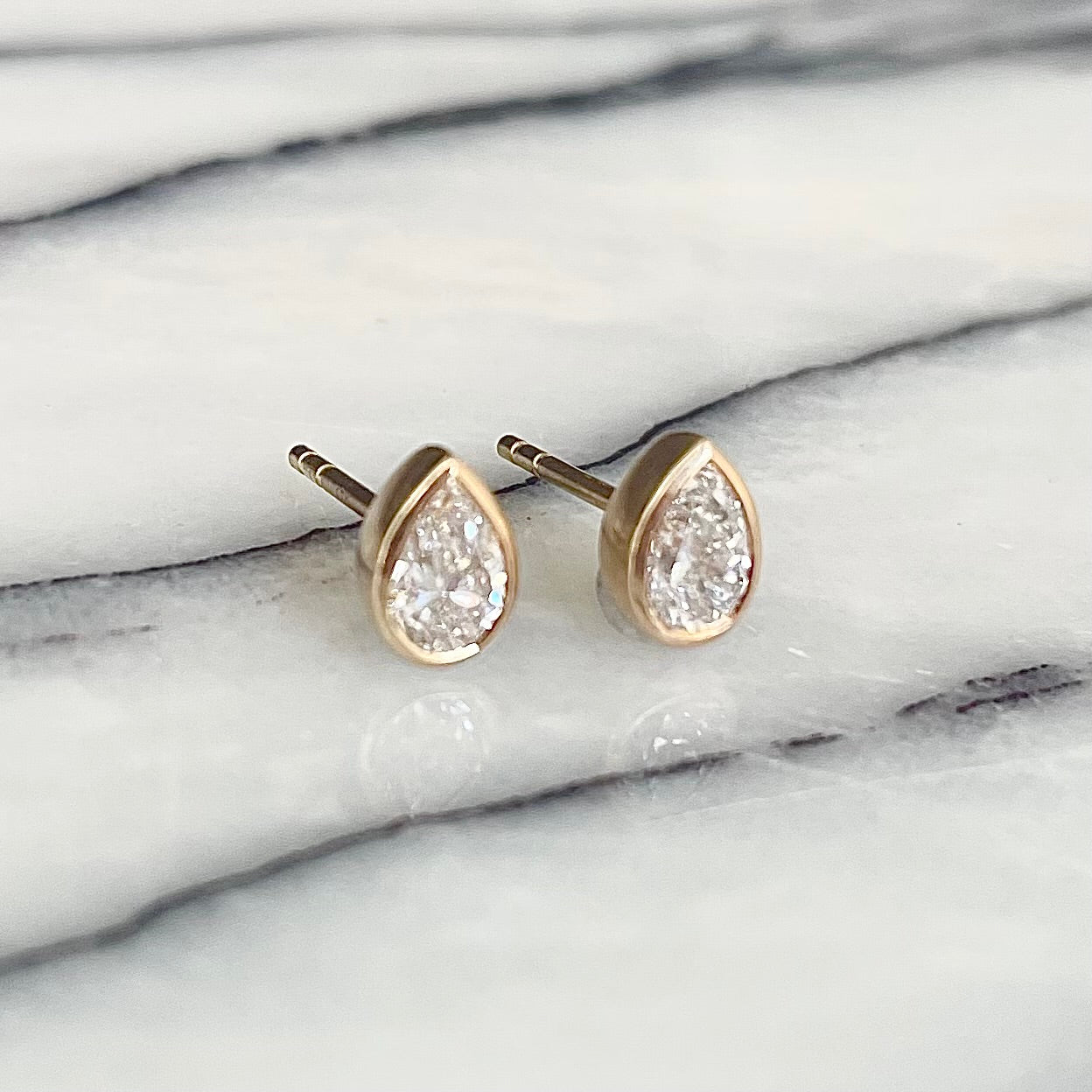 Pear Shaped diamond bezel set Earrings