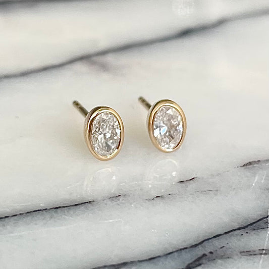 Oval Cut Diamond bezel set earrings