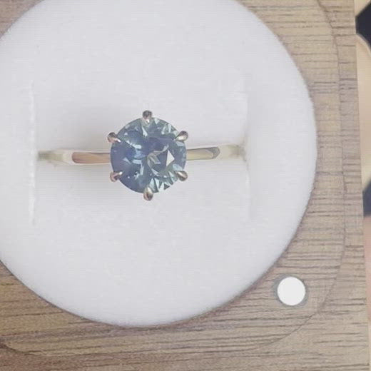 This 14ct Yellow Gold Solitare Chloe Sapphire Ring featuring a Light Blue Australian Parti Sapphire and is set with 6 claws. The band is pinched at the top, the claws are set in an eagle claw shape   The Sapphire measures 7.5mm & is 1.69ct in weight  This ring is a size L (it can be resized I-Q)   Made with recycled metal in Sydney   Ethically sourced Gemstones 