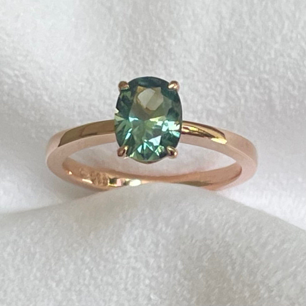 This 14ct Rose Gold Solitaire Eva Ring is beautifully complimented by a 1.33ct oval cut Australian Parti Sapphire, the stone is set with four eagle shaped claws in Rose gold. The Sapphire measures 7.7 x 5.9mm The ring is size L & can be sized to sizes I-R Made with recycled metal in Sydney Ethically sourced Gemstones