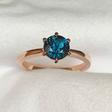 This 14ct Rose Gold Solitaire Chloe Ring is beautifully complimented by a 1.09ct teal blue Australian Sapphire, the stone is set with six eagle shaped claws in Rose gold.  The Sapphire measures 6.14ct and is 1.09cts   The ring is size L & can be sized to sizes I-R   Made with recycled metal in Sydney   Ethically sourced Gemstones 