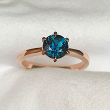 Load image into Gallery viewer, This 14ct Rose Gold Solitaire Chloe Ring is beautifully complimented by a 1.09ct teal blue Australian Sapphire, the stone is set with six eagle shaped claws in Rose gold.  The Sapphire measures 6.14ct and is 1.09cts   The ring is size L &amp; can be sized to sizes I-R   Made with recycled metal in Sydney   Ethically sourced Gemstones 